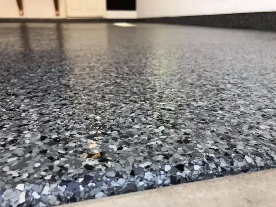 Epoxy garage floor with dark gray speckled flakes